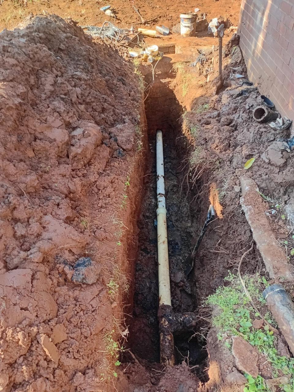 Excavated trench prepared for underground pipe installation